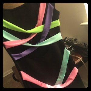 Black fitted dress with pastel straps across back.